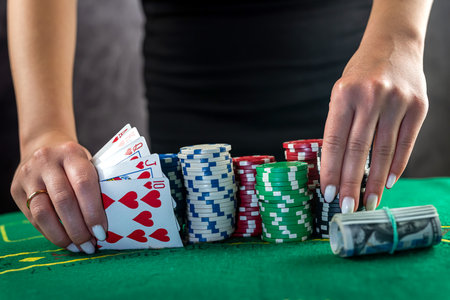 Young woman taking money from her wallet betting everything in a risky game of poker. raising the stake in pokerの写真素材