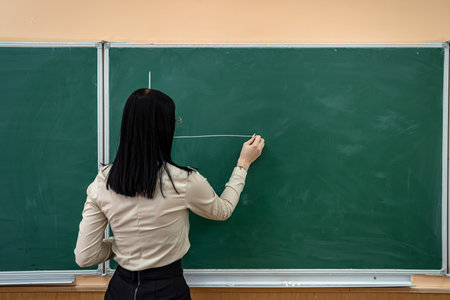 a new young luxurious brunette teacher appeared in the new prestigious school. The concept of a young teacherの写真素材