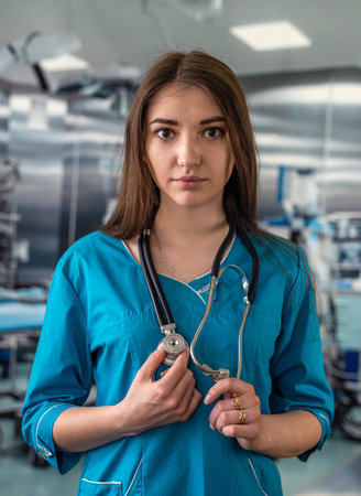 Portrait of female nurse in white uniform and stethoscope in operating room in hospital. medical concept. doctor with a stethoscope.の写真素材