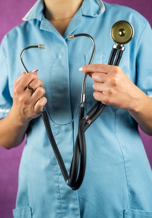 Portrait of female doctor in uniform with stethoscope isolated on plain background.nurse or doctor. health care hands with a stethoscopeの写真素材