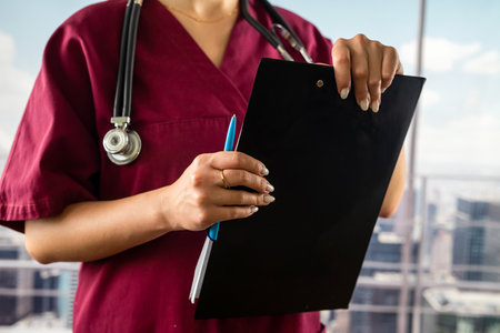 Cropped image of nurse holding folder with documents in hallway of main hospital. medicine. the doctor is in the corridor. hands close upの写真素材