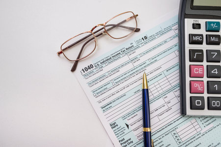 form 1040 with pen bitcoin coins calculator financial document. paperwork. tax forms submission of...