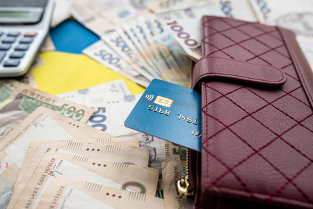 calculator with credit card on ukraine money in purse as financial background, saving concept, wealthy all for shoppingの写真素材