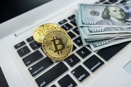 bitcoin useful coin on laptop computer keyboard isolated on black background. business exchange....