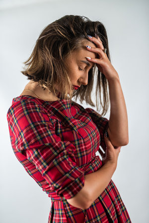 Young beautiful woman wearing stylish clothes over isolated background suffering from headache and despair. Hands on head. headache. migraine.の写真素材