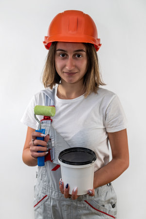Young woman with repair tools in special clothes isolated on white background. construction. house repairの写真素材