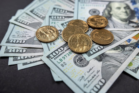 Golden bitcoin symbolic coin isolated on hundred dollar bills. Exchange bitcoin cash for dollars....