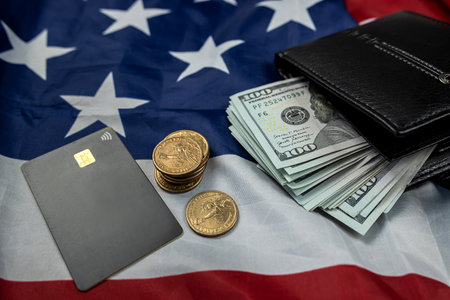 Leather wallet with one hundred dollar bills isolated on USA flag background. prosperity of the country. a symbol of wealth.の写真素材