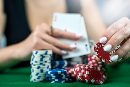 beautiful woman in an evening black dress plays poker in a casino at a green table. Takes a bet on...