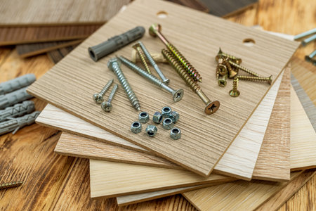 samples of wooden bars for decoration of shop windows and screws with dowels close-up photo. repair conceptの写真素材