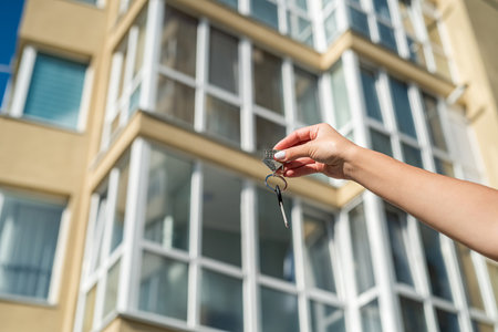 Mature happy home owner man or realtor or buyer showing a bunch of keys to a new property or apartment or rental house. real estate conceptの写真素材