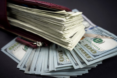 Open black wallet with cash US dollar bills isolated on plain background. View from aboveの写真素材