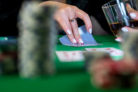 beautiful young woman with cards in her hands makes a card move in poker. poker game women in poker...