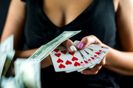 woman in black counts chips for money and raises bet while playing poker in casino. gambling concept. woman and poker.の写真素材
