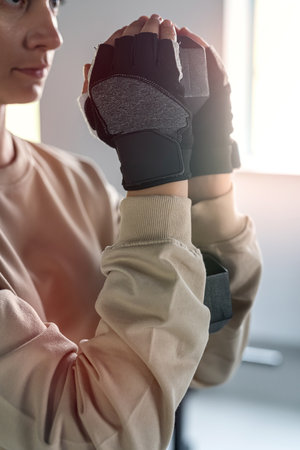 Sporty woman performs exercises with dumbbells in the gym. Photo of a muscular woman in sportswear. strength and motivation.の写真素材