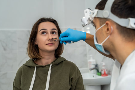 male doctor or ENT specialist with a patient in his practice examining the nose with an endoscope. medicine. rhinitisの写真素材