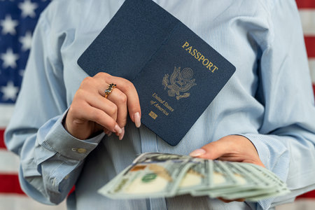 Beautiful woman holding a passport with money dollars for traveling abroad. the concept of traveling abroad. tourism conceptの写真素材