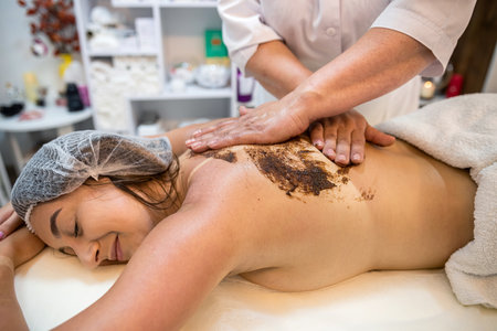 professional female masseuse massages a client's back on a massage table, close-up. healthy back Healthy Lifestyleの写真素材