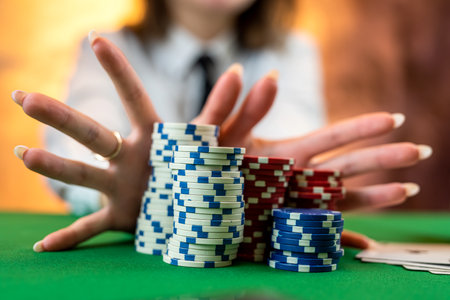 beautiful young woman poker player discards playing cards by throwing them on the table. professional poker games. Green poker table with two games. isolatedの写真素材