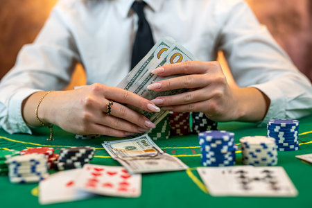 female player counts chips for money and raises bet while playing poker in casino. gambling concept. woman and poker. isolatedの写真素材