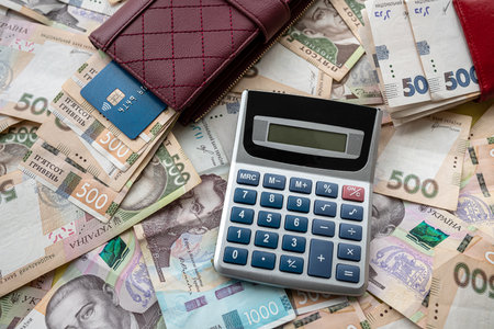 calculator with credit card on ukraine money in purse as financial background, saving concept, wealthy all for shoppingの写真素材