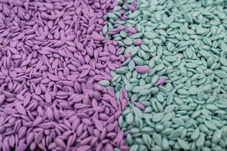 granules of turquoise and purple depilatory wax scattered. background from granules.の写真素材