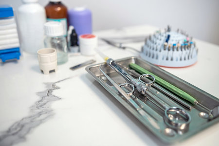 Dental tweezers lie in a metal tray and a bunch of other parts. dentistryの写真素材
