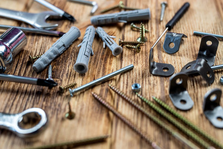Screws and dowels for hanging objects shown on isolated wood background. repair conceptの写真素材