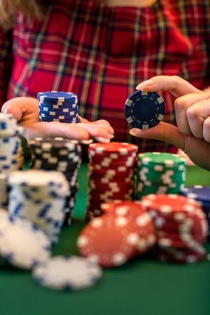 cropped portrait of a young girl playing a men's game at a poker table. poker game concept. big kush isolatedの写真素材