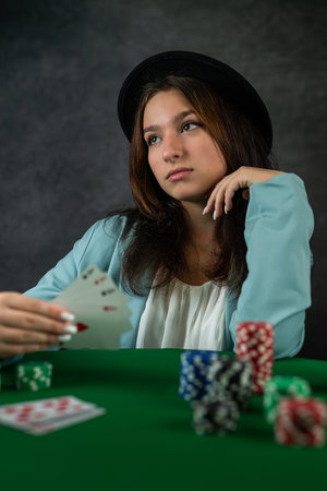 Beautiful poker girl starts a poker game with cards and chips on the table. poker game concept....