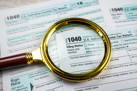 blank of individual tax form with magnifying glasses, tax and income conceptの写真素材