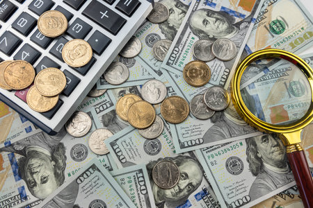 us 100 dollar bills and coin cent calculator, magnifying glass. Investment loan capital, finance conceptの写真素材