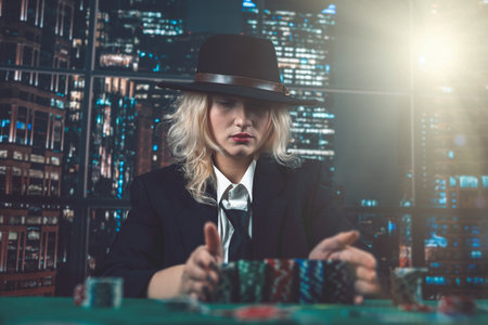 dealer's or croupier's girlfriend lays out poker cards in a local expensive casino. poker game concept. gaming business. girl dealerの写真素材