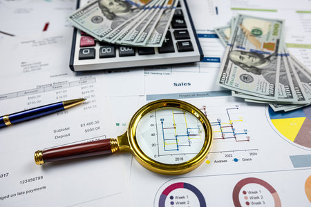 business concept investment chart reports with magnifying glass and calculator on desk. financial saving conceptの写真素材