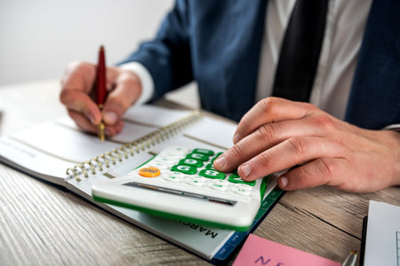 man work with finance graph and chart at office. Accounting conceptの写真素材