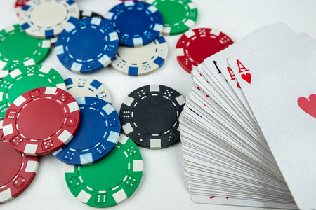 different playing cards and poker chips isolated on white background. Gambling concept