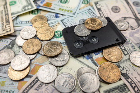 buying a car dollar coinand paper cash with keys. insurance concept. Sell or rentの写真素材