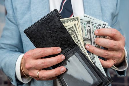 man in suit accouinting money from puse and give as bribe. illegal concept