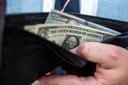 Business Man in suit accounting dollar money from the wallet, financial concept
