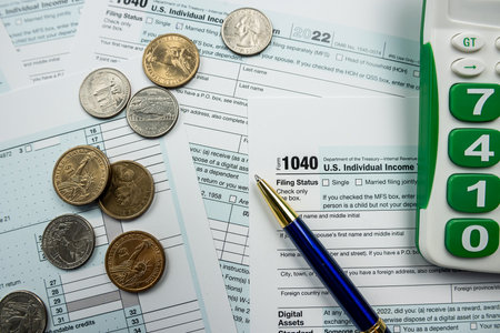 1040 Individual income tax return form with pen and calculator. Accounting financial conceptの写真素材