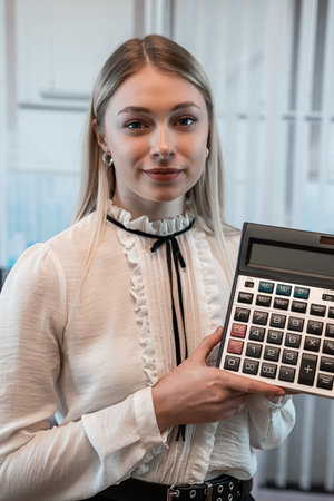 Businesswoman shows calculator at office. Female manager, analysis statistical conceptの写真素材