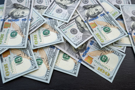 Pile of new 100 dollar banknotes bills on black. finance concept. Rich and savingの写真素材