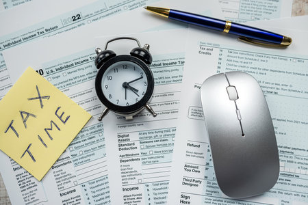 yellow sticker with world Tax Time on 1040 tax form, Tax concept deadlineの写真素材