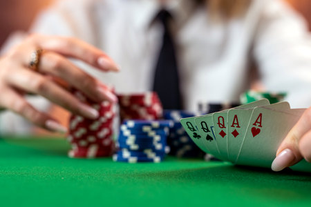 woman's hand on a pile of poker chips at a round poker table. risky bets in poker. isolated on plain...