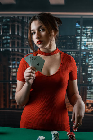 Attractive young woman in a red dress holding a combination of poker cards. poker. Gambling. cards...
