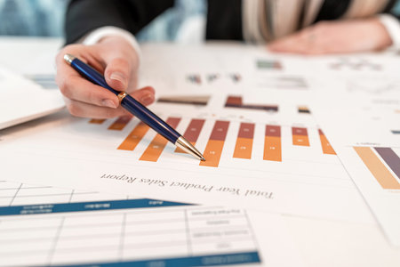 Business woman working alone at the office with statistics charts and graph. Paperworks, finance...