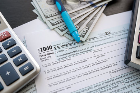 2022 blank tax form with money cash pen and calculator. Taxation deadline concept. 15 April