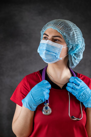 portrait of female doctor wear uniform with medical face mask and medical gloves, stethoscope. Medical conceptの写真素材
