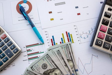 Annual report financial charts with pen, calculator and dollar. Finance investment conceptの写真素材