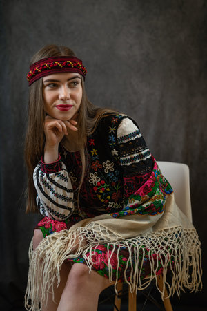Beautiful ukrainian young woman wear ethnic embroidered blouse at dark background, independence day,...